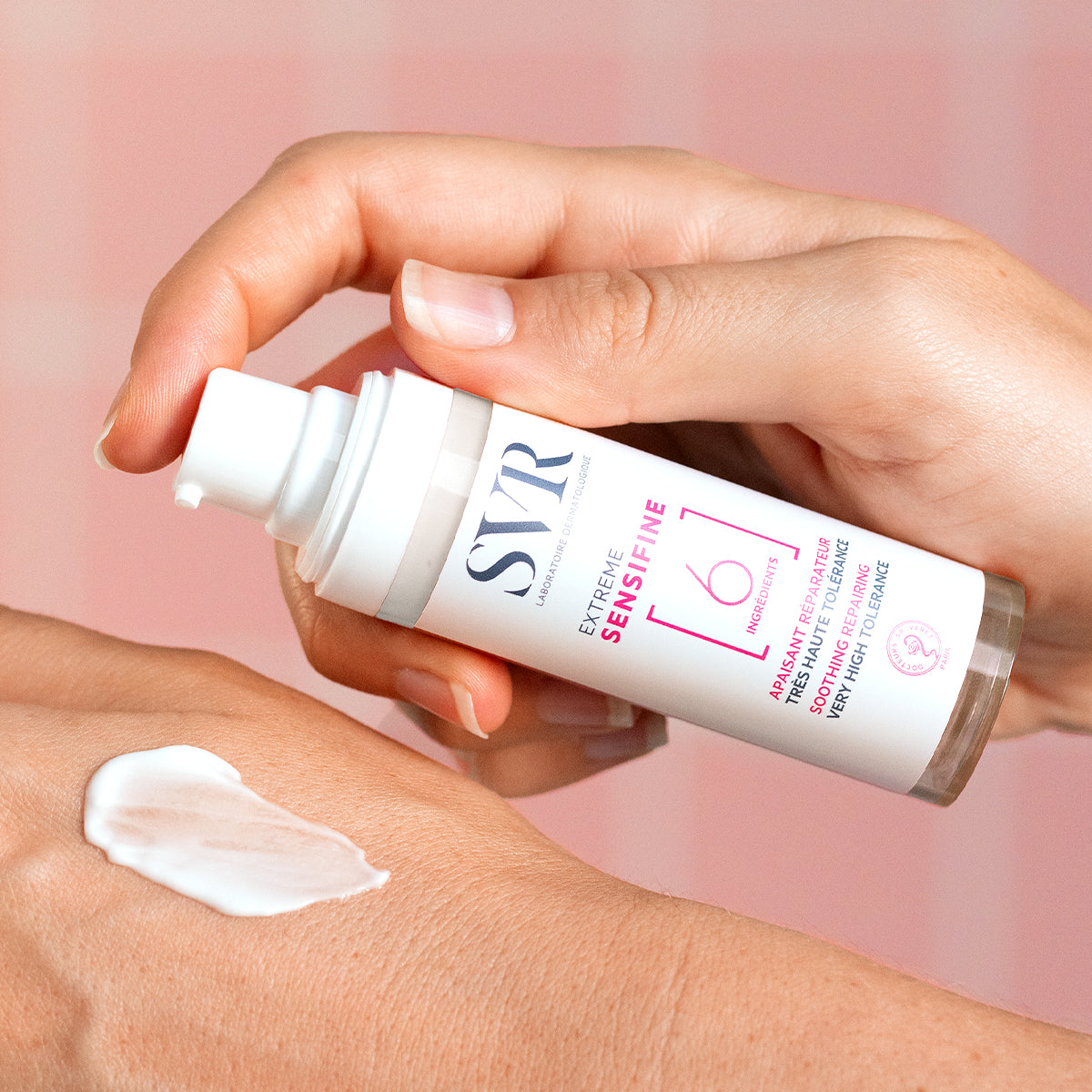 SVR Sensifine Extreme soothing repair cream in a white pump bottle being applied to skin.